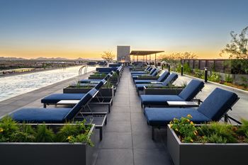 Expansive sundeck with poolside lounge chairs